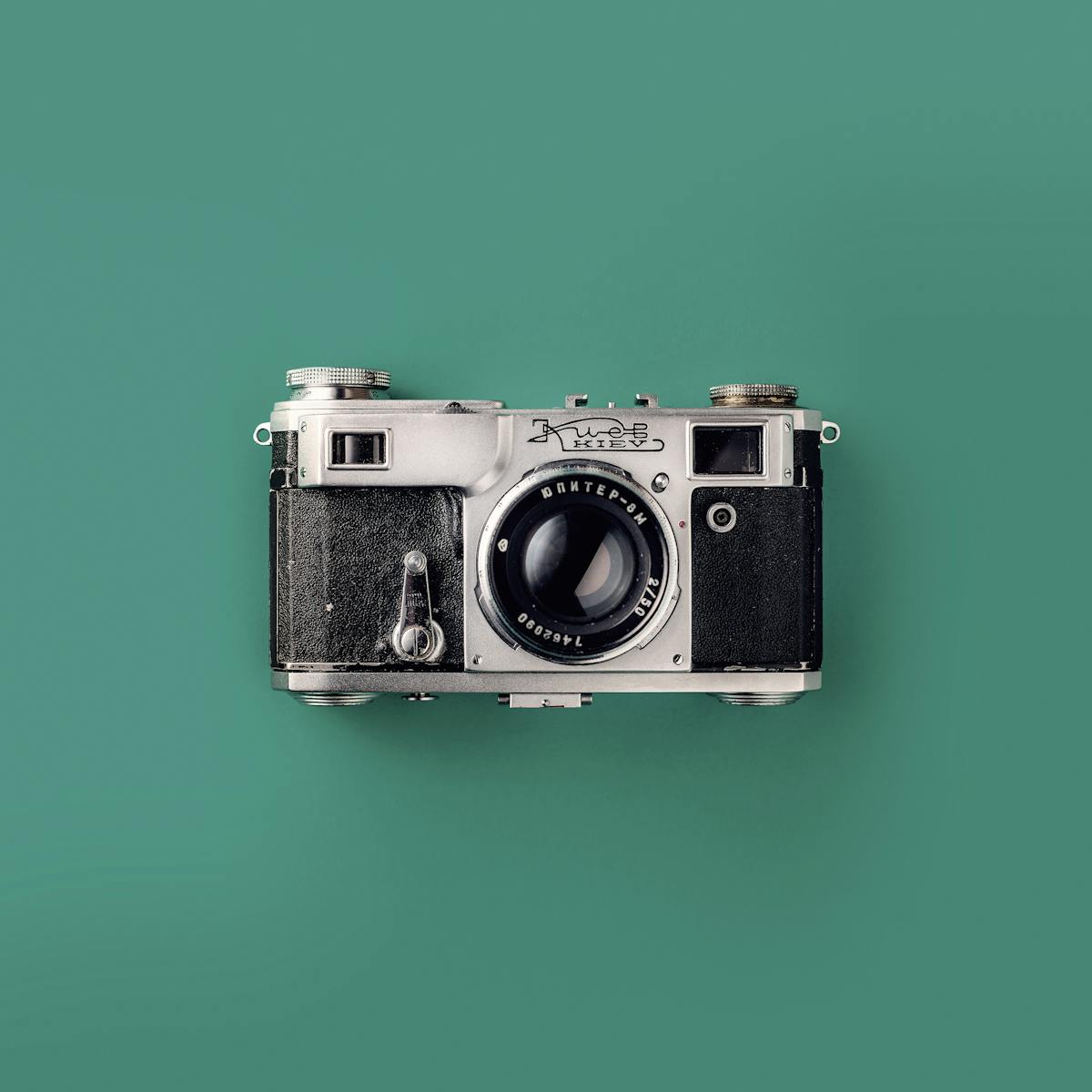 Classic vintage camera with a green background, symbolizing retro photography and nostalgia.